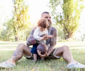 Father with children playing rugby Stock Photo