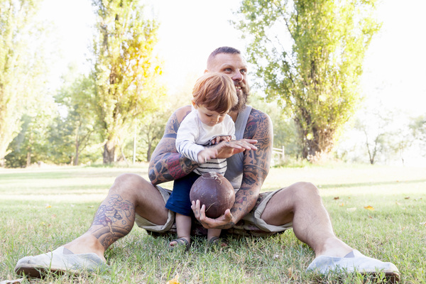 Father with children playing rugby Stock Photo