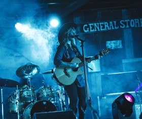 Female singer performing on smoke stage Stock Photo