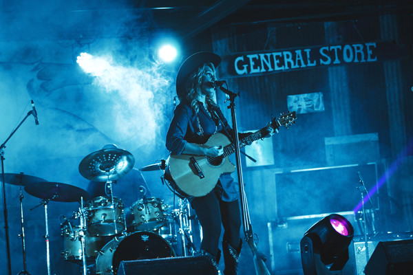 Female singer performing on smoke stage Stock Photo