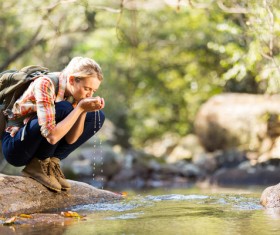 Female tourist drinking spring water Stock Photo