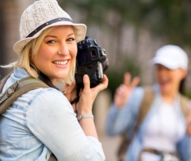 Female tourist using camera to take photos Stock Photo