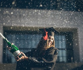Girl excited with cheering champagne in graduation ceremony Stock Photo