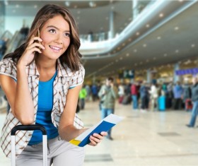 Girl is phoning in airport waiting room Stock Photo