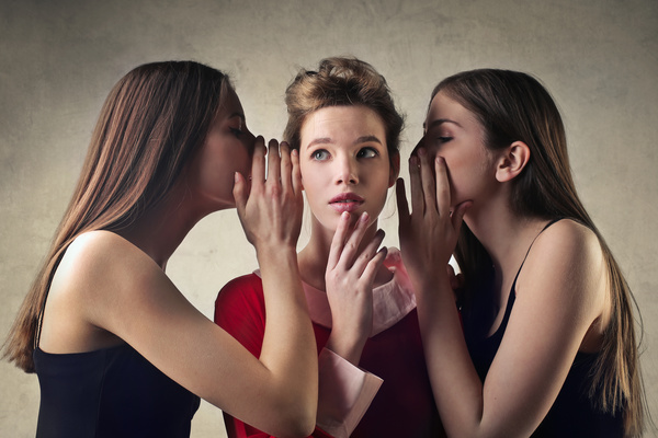 Girls whispering Stock Photo