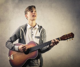 Handsome boy plays guitar Stock Photo