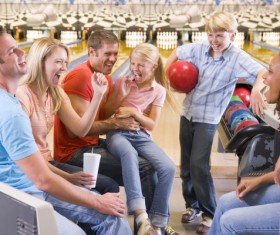 Happy family in bowling alley Stock Photo