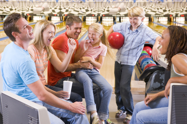 Happy family in bowling alley Stock Photo