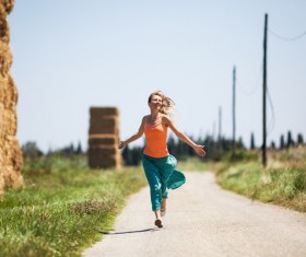 Happy girl running on the road Stock Photo