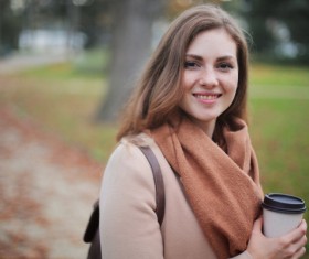 Holding coffee cup in hand autumn outfit girl Stock Photo