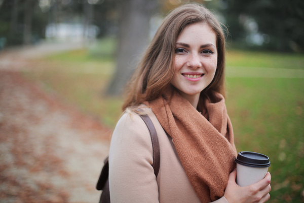 Holding coffee cup in hand autumn outfit girl Stock Photo