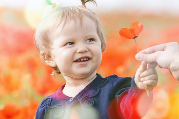 Holding red flowers cute little girl Stock Photo