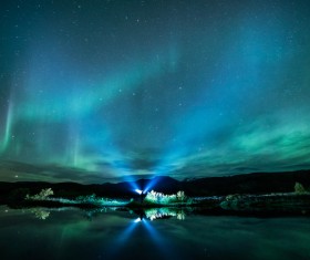 Lights on calm lake at night Stock Photo