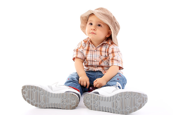 Little boy wearing fathers shoes Stock Photo