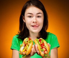 Little girl eating hot dog Stock Photo