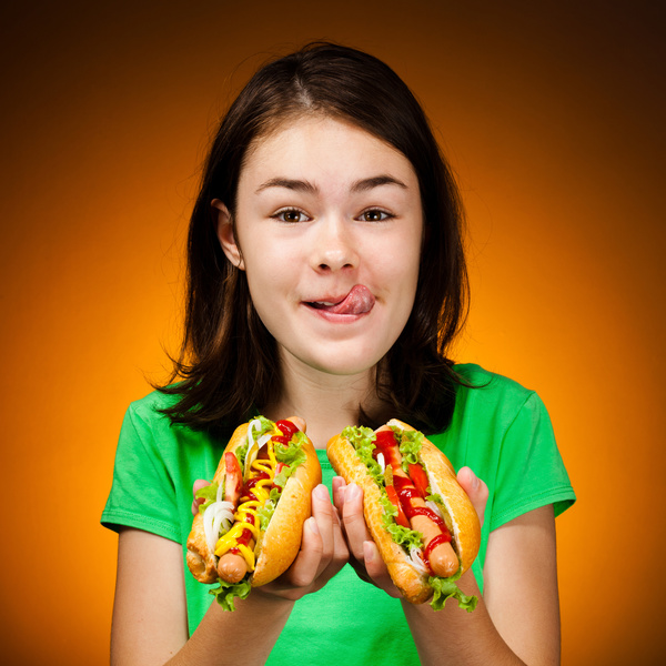 Little girl eating hot dog Stock Photo