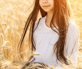 Little girl holding bread in wheat field Stock Photo 02