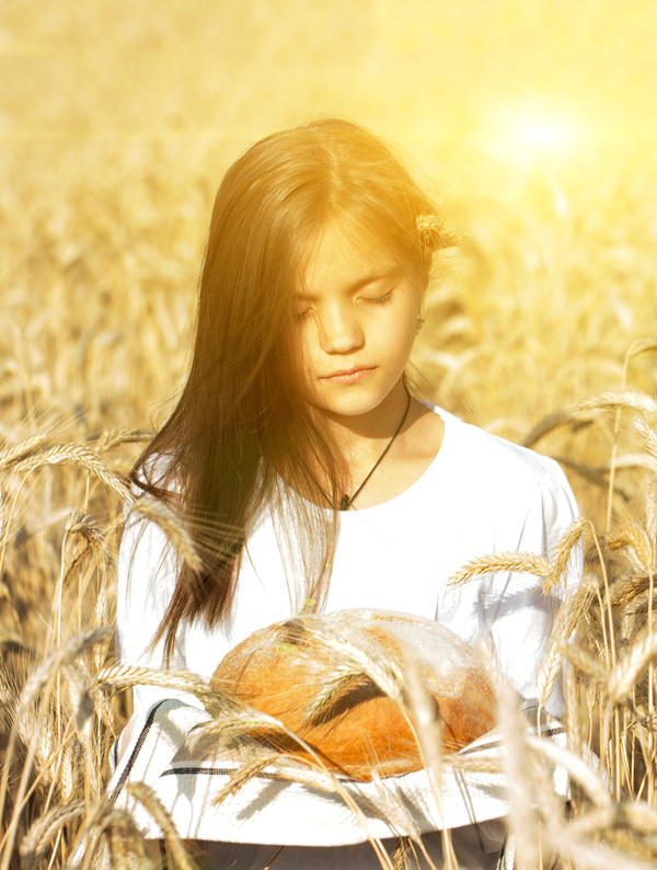 Little girl holding bread in wheat field Stock Photo 03