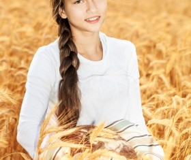 Little girl holding bread in wheat field Stock Photo 04