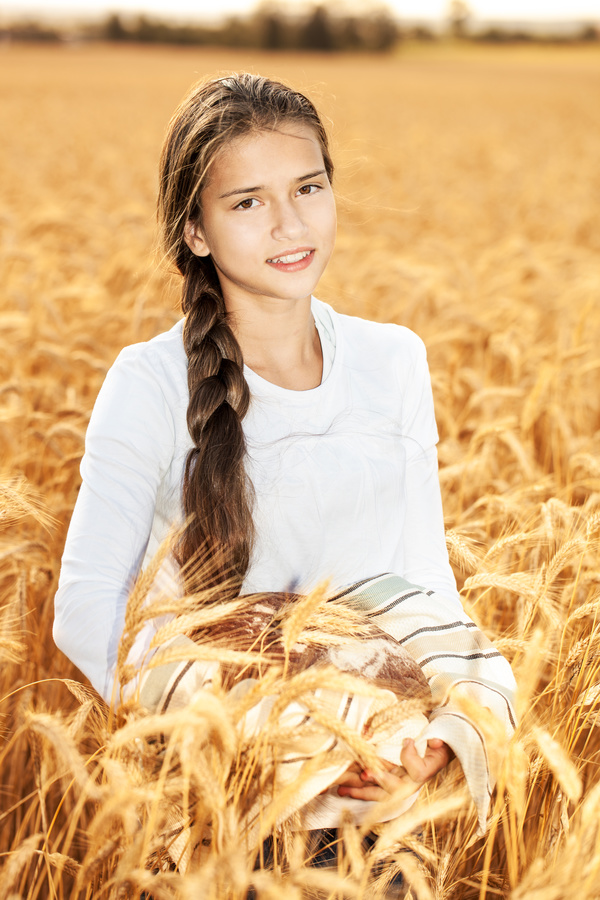 Little girl holding bread in wheat field Stock Photo 04