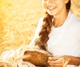 Little girl holding bread in wheat field Stock Photo 05
