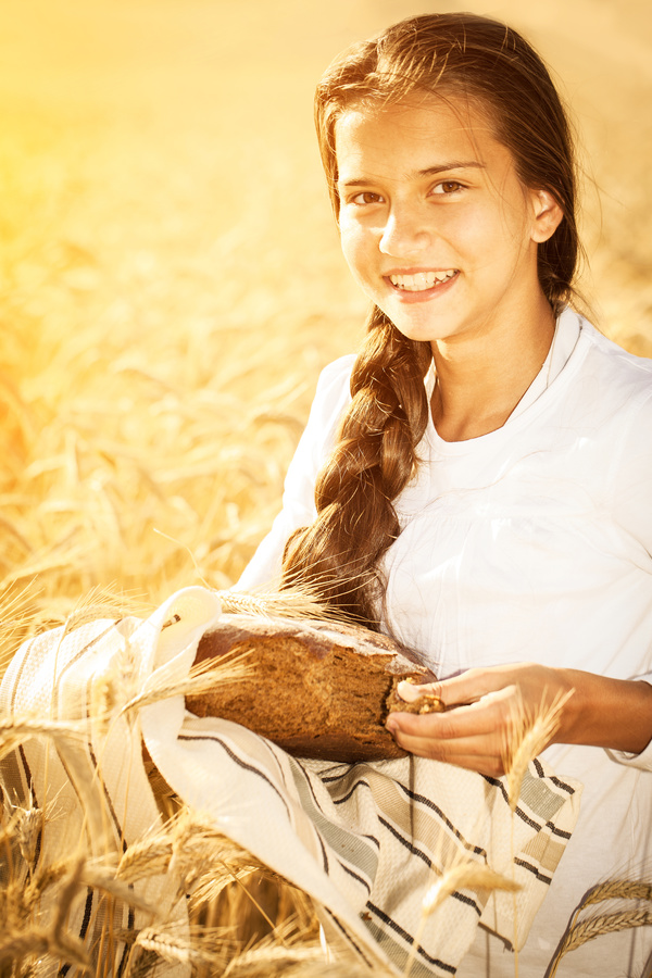 Little girl holding bread in wheat field Stock Photo 05