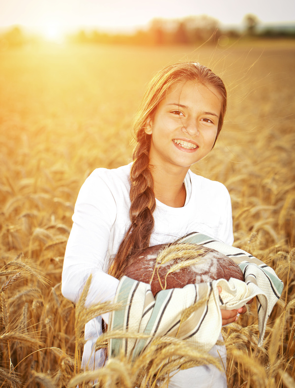 Little girl holding bread in wheat field Stock Photo 06