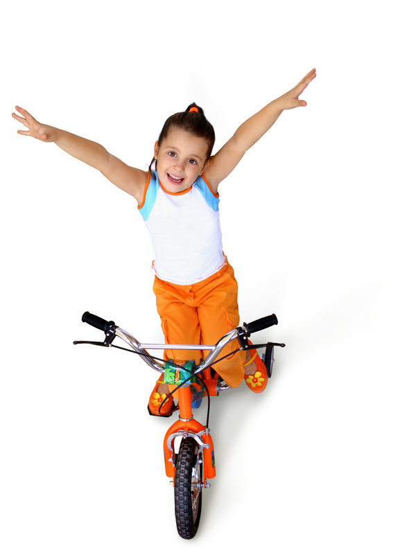 Little girl rides bicycle Stock Photo