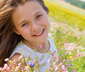 Little girl standing on wildflower meadow Stock Photo 01