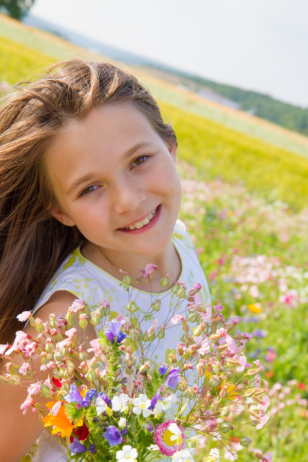 Little girl standing on wildflower meadow Stock Photo 01