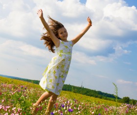 Little girl standing on wildflower meadow Stock Photo 02
