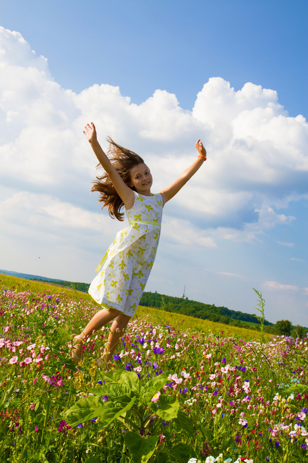 Little girl standing on wildflower meadow Stock Photo 02