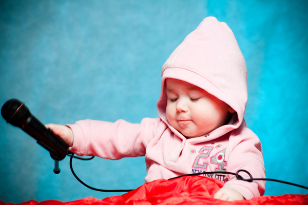 Little kid playing with microphone Stock Photo