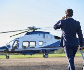 Man preparing to ride helicopter Stock Photo