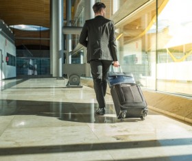 Man pulling a suitcase Stock Photo
