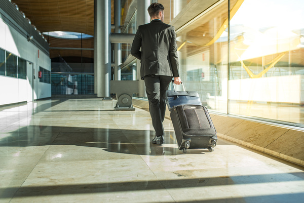 Man pulling a suitcase Stock Photo