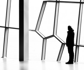 Man standing in front of geometric window Stock Photo