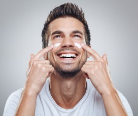 Man wiping moisturizers and creams Stock Photo