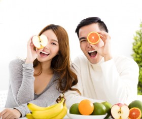 Men and women holding fruits Stock Photo