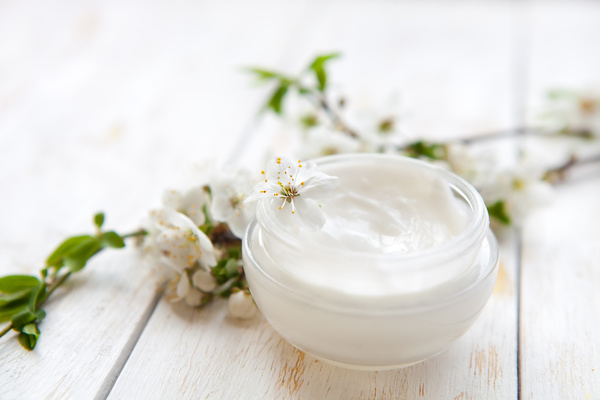 Moisturizers and creams and flowers Stock Photo