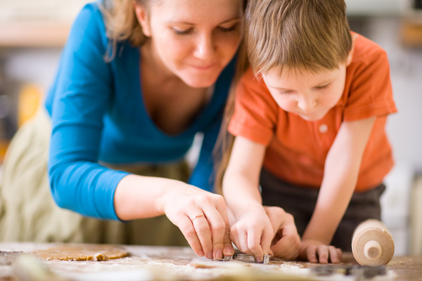 Mother teaching children to cook Stock Photo