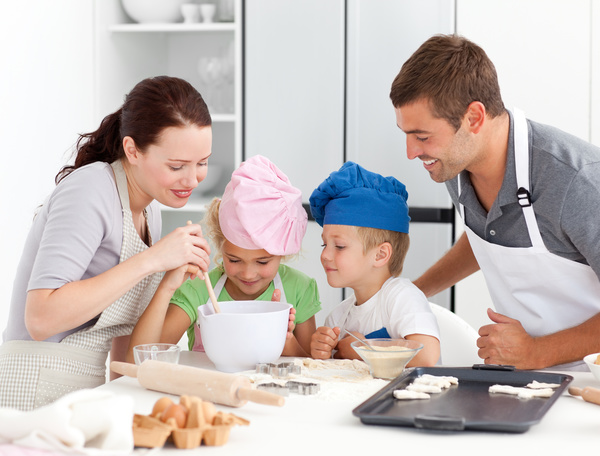 Parents and children cooking in the kitchen Stock Photo 02