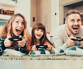 Parents play video games with their children Stock Photo 01