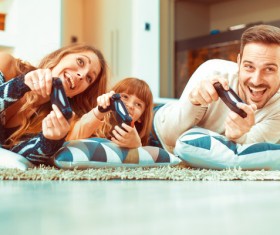 Parents play video games with their children Stock Photo 02