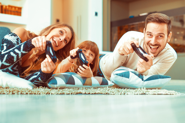 Parents play video games with their children Stock Photo 02