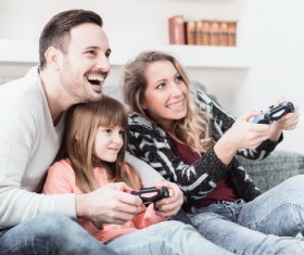Parents play video games with their children Stock Photo 04