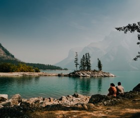 People sitting relaxed by the lake Stock Photo
