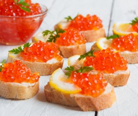 Red caviar on bread with lemon and parsley Stock Photo 01