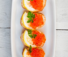 Red caviar on bread with lemon and parsley Stock Photo 03