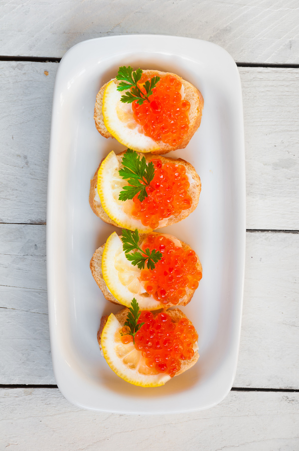 Red caviar on bread with lemon and parsley Stock Photo 03